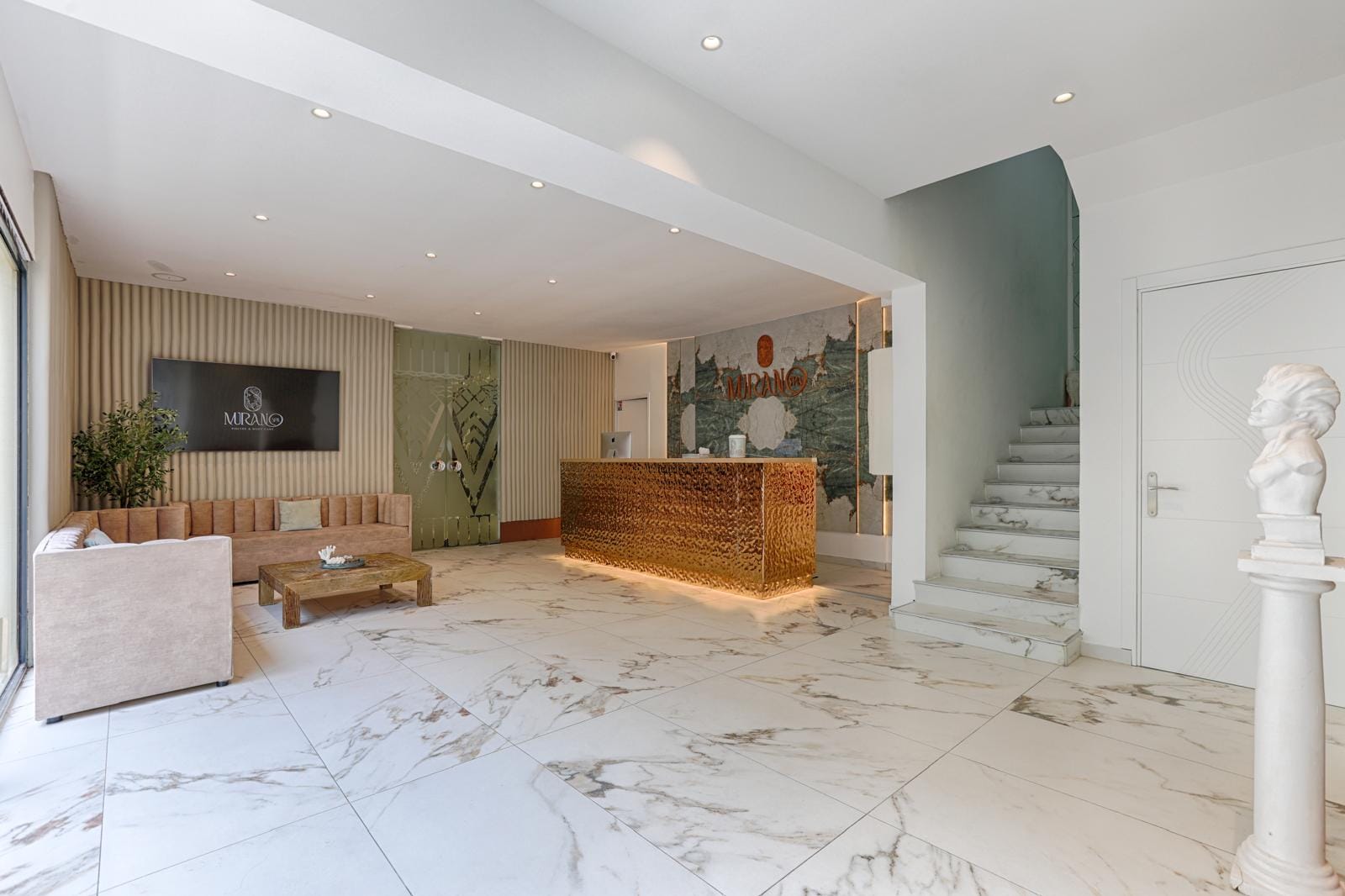 Reception of the Murano spa in Paris — marble, designer furniture and warm lighting